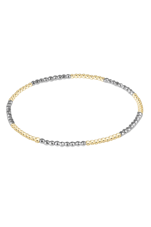Three-strand beaded necklace in gold, silver, and gray on a white background. gold. silver. enewton. tarnishfree. metallic. stackable. bracelets.
