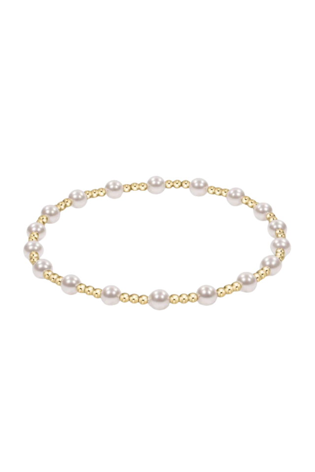 Pearl bracelet with gold accents on a white background