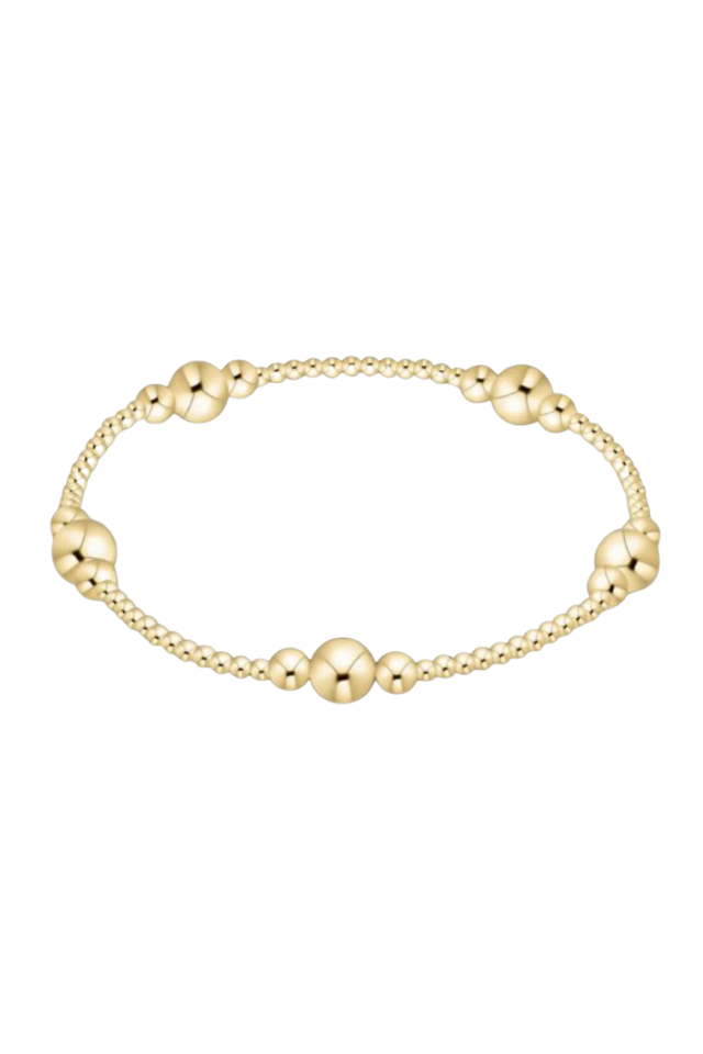 Gold bracelet with round beads on a white background.  Gold beaded bracelet on a white background. enewton. 14k gold, tarnish free. low price. 