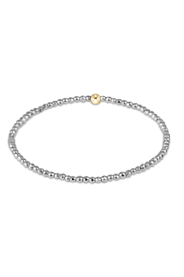 Silver beaded necklace with a gold clasp on a white background. gold. silver. enewton. tarnishfree. metallic. stackable. bracelets.