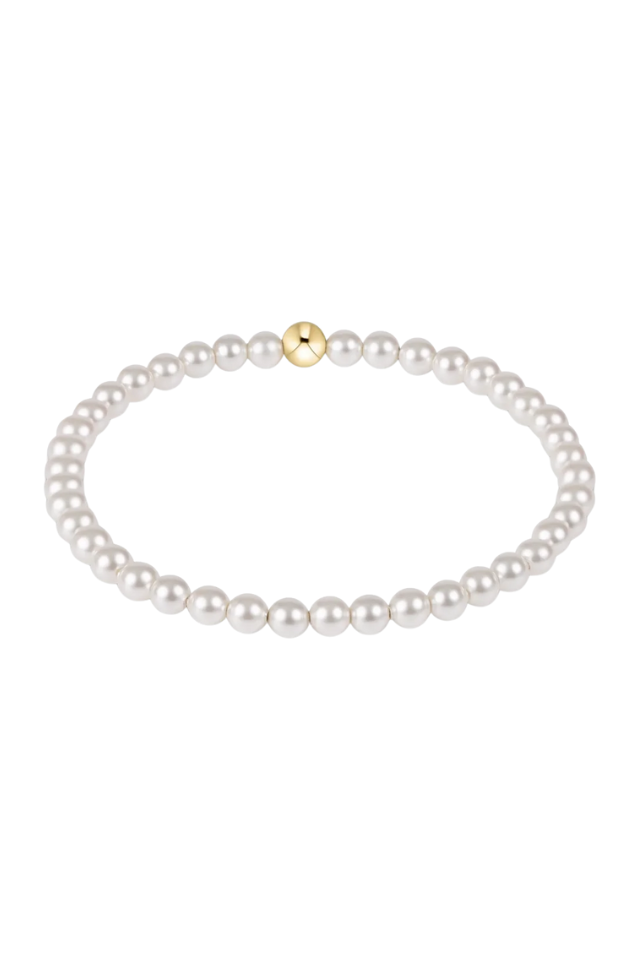Pearl necklace with a gold clasp on a white background. gold. silver. enewton. tarnishfree. metallic. stackable. bracelets.