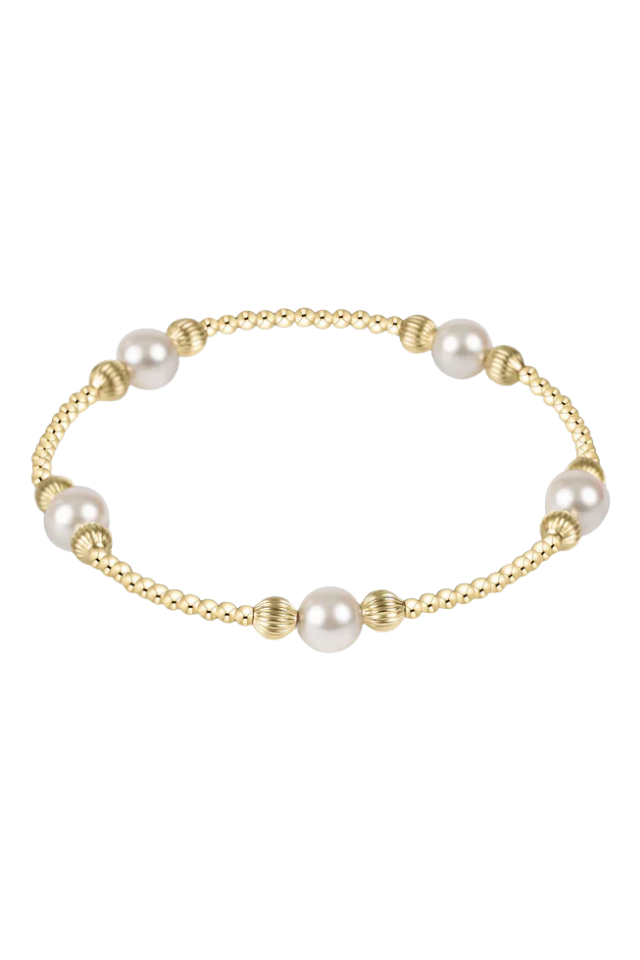 Gold bracelet with pearls on a white background. gold. silver. enewton. tarnishfree. metallic. stackable. bracelets.