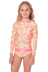 Young girl wearing a floral long-sleeve swimsuit on a white background maaji rashguard set 