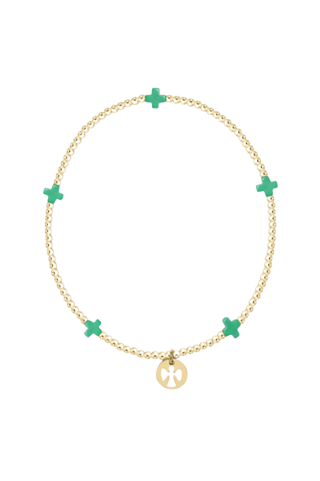 Gold bracelet with green crosses on a white background.Gold beaded bracelet on a white background. enewton. 14k gold, tarnish free. low price. camp mystic 