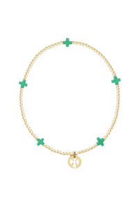 Gold bracelet with green crosses on a white background.Gold beaded bracelet on a white background. enewton. 14k gold, tarnish free. low price. camp mystic 